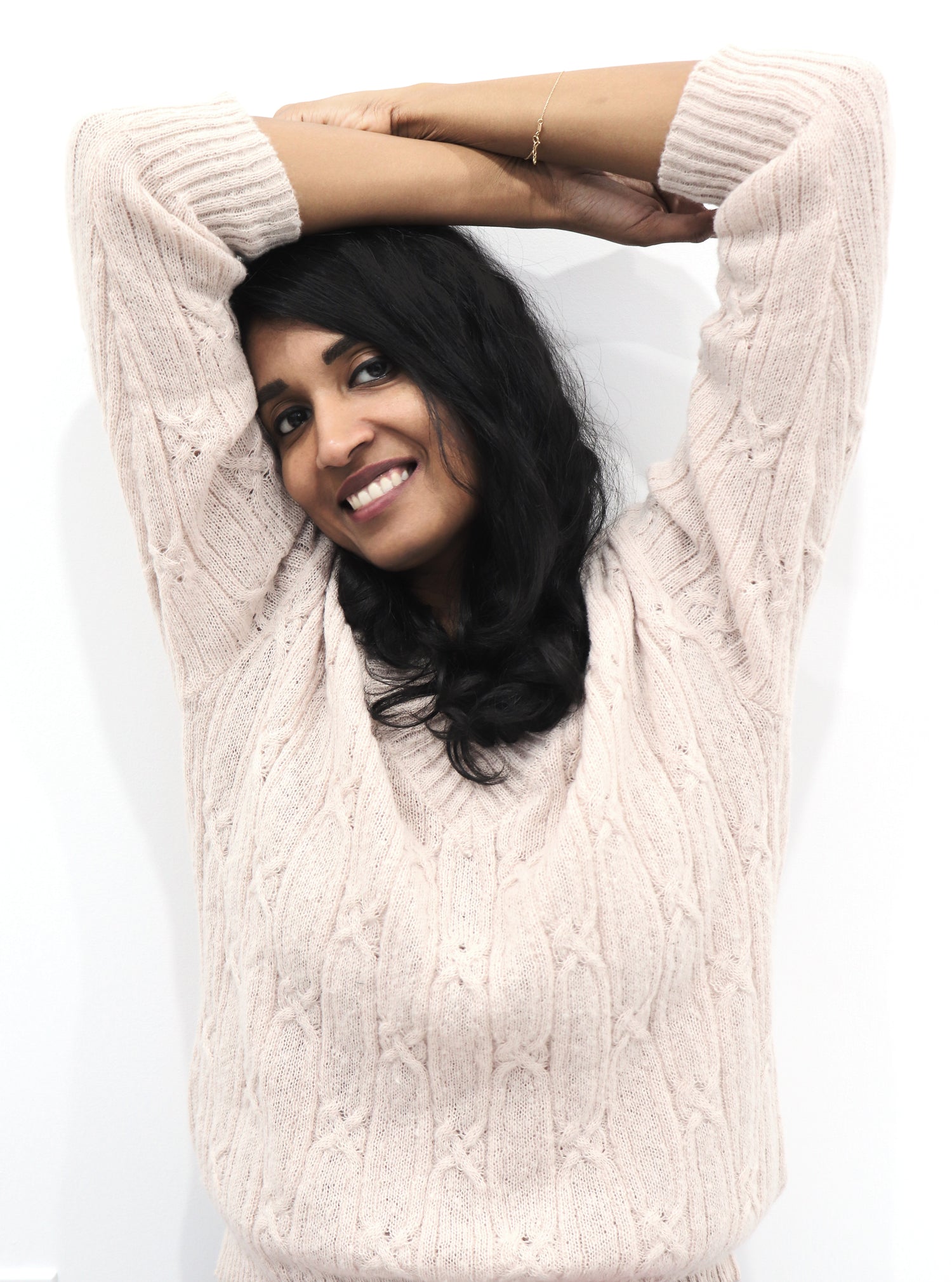 Shruti Shankar, founder of Home Set Match, standing with skin-friendly, eco-friendly allergy safe Tencel bedding designed for sensitive skin and a restful sleep